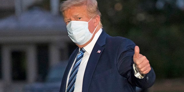 President Donald Trump gives a thumbs-up as he returns to the White House Monday, Oct. 5, 2020, in Washington, after leaving Walter Reed National Military Medical Center, in Bethesda, Md. (AP Photo/Alex Brandon)