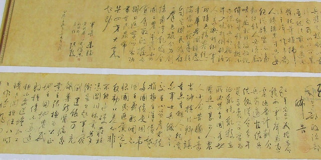 In this photo provided by Hong Kong Police Force, two pieces of a calligraphy scroll by former Chinese leader Mao Zedong estimated to be worth about $  296.7 million are displayed in Hong Kong, Tuesday, Oct. 6, 2020. (Hong Kong Police Force via AP)