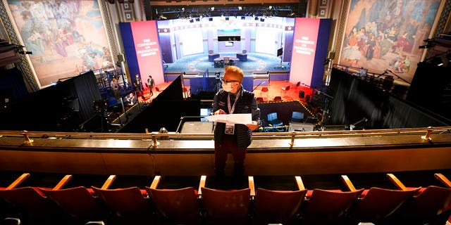 A member of the production staff holds a seating chart while putting labels on chairs socially distanced from each other ahead of the vice presidential debate at the University of Utah, Wednesday, Oct. 7, 2020, in Salt Lake City. Vice President Mike Pence and Democratic vice presidential candidate, Sen. Kamala Harris, D-Calif., will participate in the debate Wednesday night. (AP Photo/Julio Cortez)