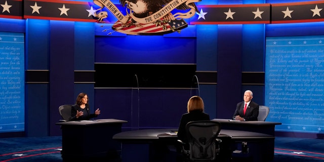 Vice President Mike Pence listens as Democratic vice presidential candidate Sen. Kamala Harris, D-Calif., makes a point during the vice presidential debate Wednesday, Oct. 7, 2020, at Kingsbury Hall on the campus of the University of Utah in Salt Lake City. (AP Photo/Patrick Semansky)