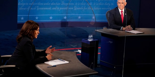 Vice President Mike Pence looks at Democratic vice presidential candidate Sen. Kamala Harris, D-Calif., as she answers a question during the vice presidential debate Wednesday, Oct. 7, 2020, at Kingsbury Hall on the campus of the University of Utah in Salt Lake City. (AP Photo/Morry Gash, Pool)