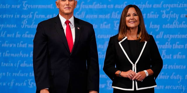 Vice President Mike Pence stands with his wife Karen Pence following the vice presidential debate with Democratic vice presidential candidate Sen. Kamala Harris, D-Calif., Wednesday, Oct. 7, 2020, at Kingsbury Hall on the campus of the University of Utah in Salt Lake City. (AP Photo/Patrick Semansky)