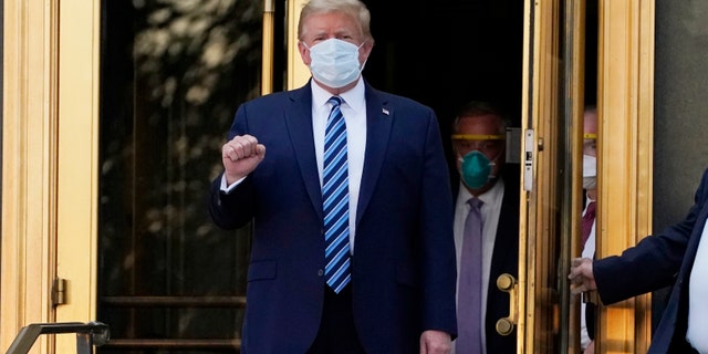 President Donald Trump walks out of Walter Reed National Military Medical Center to return to the White House after receiving treatments for COVID-19, Monday, Oct. 5, 2020, in Bethesda, Md. (AP Photo/Evan Vucci)