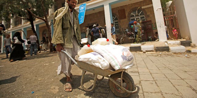 FILE: A displaced Yemeni receives food aid provided by the World Food Program, at a school in Sanaa, Yemen. 