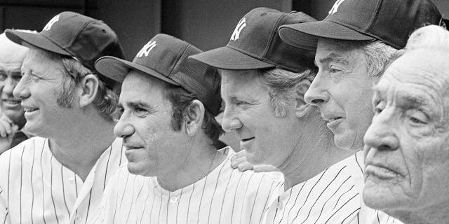 In this Aug. 3, 1974, file photo, New York Yankees, from left, Mickey Mantle, Yogi Berra, Whitey Ford, Joe DiMaggio and Casey Stengel gather on the steps of Shea Stadium in New York before an Old Timer's game. A family member tells The Associated Press on Friday, Oct. 9, 2020, that Ford died at his Long Island home Thursday night. (AP Photo/Ray Stubblebine, File)
