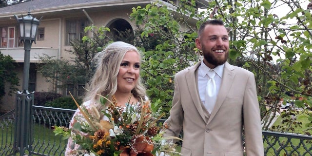 In this image made from video, Ian and Taylor Gaspard from Abbeville speak to a reporter after getting married Thursday. Hurricane Delta sped up the Louisiana couple's wedding by a few days but judging by the smiles on the bride and groom it certainly didn't dampen the affair. (AP Photo/Rebecca Santana)