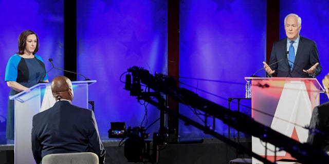 Republican U.S. Sen. John Cornyn, of Texas, back right, speaks during a debate with MJ Hegar, of Round Rock, left, Friday, Oct. 9, 2020, in Austin, Texas. (Bob Daemmrich/Nexstar/KXAN via AP, Pool)