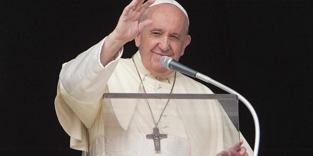 Pope Francis delivers his blessing as he recites the Angelus noon prayer from the window of his studio overlooking St. Peter's Square at the Vatican on Sept. 20, 2020.