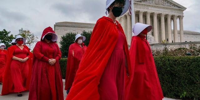Activists opposed to the confirmation of President Donald Trump's Supreme Court nominee, Judge Amy Coney Barrett, are dressed as characters from 
