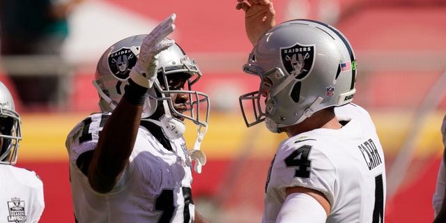 Las Vegas Raiders wide receiver Nelson Agholor, left, celebrates with quarterback Derek Carr after catching a 59-yard touchdown pass during the first half of a game against the Kansas City Chiefs, Sunday, Oct. 11, 2020, in Kansas City.