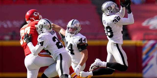 Las Vegas Raiders safety Jeff Heath (38) intercepts a pass intended for Kansas City Chiefs tight end Travis Kelce (87) during the second half of an NFL football game, Sunday, Oct. 11, 2020, in Kansas City. (AP Photo/Jeff Roberson)