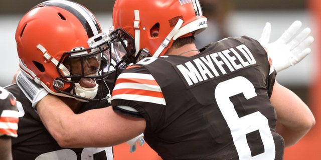 Cleveland Browns wide receiver Rashard Higgins (82) and quarterback Baker Mayfield celebrate after a 15-yard touchdown by Higgins during the first half of an NFL football game against the Indianapolis Colts, Sunday, Oct. 11, 2020, in Cleveland. (AP Photo/David Richard)