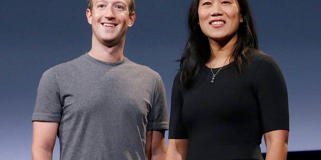 Facebook CEO Mark Zuckerberg and his wife, Priscilla Chan, smile as they prepare for a speech in San Francisco.