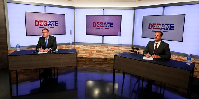 U.S. Sen. Mark Warner, D-Va., left, and Republican challenger Daniel Gade, right, prepare for a debate at a television studio Oct. 13, in Richmond, Va. (AP Photo/Steve Helber)