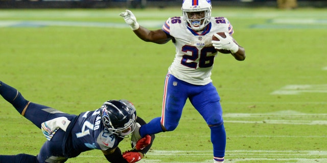 Buffalo Bills running back Devin Singletary (26) gets away from Tennessee Titans strong safety Kenny Vaccaro (24) in the second half of an NFL football game Tuesday, Oct. 13, 2020, in Nashville, Tenn. (AP Photo/Mark Zaleski)