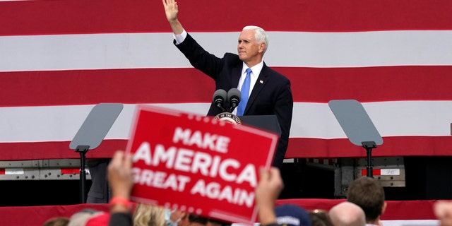 Vice President Mike Pence waves after speaking at a campaign rally, Wednesday, Oct. 14, 2020, in Grand Rapids, Mich. (Carlos Osorio)