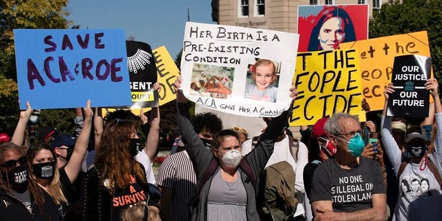 Protesters opposed to the confirmation of President Donald Trump's Supreme Court nominee Amy Coney Barrett, rally at the Supreme Court on Capitol Hill, in Washington, Wednesday, Oct. 14, 2020. (AP Photo/Jose Luis Magana)