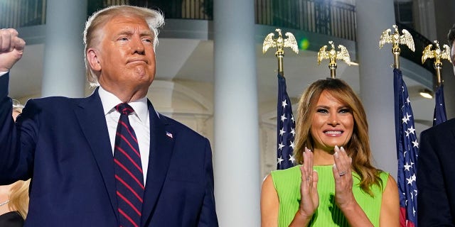 President Trump and first lady Melania Trump stand on the South Lawn of the White House, Aug. 27, 2020, in Washington. (Associated Press)