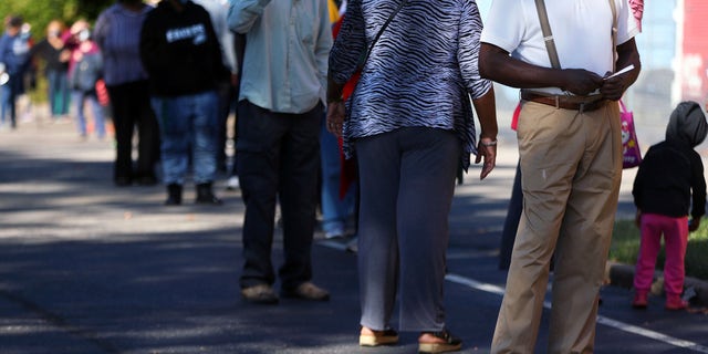 Voters wait on line at the Pursuit of God Church, Wednesday, Oct. 14, 2020, in Memphis, Tenn., on the first day of Tennessee's early voting. (Patrick Lantrip/Daily Memphian via AP)