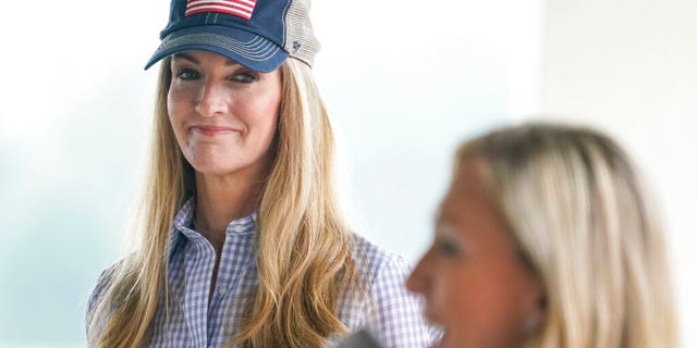 Sen. Kelly Loeffler, R-Ga., listens to Republican congressional candidate Marjorie Taylor Greene speak during a news conference on Thursday, Oct. 15, 2020, in Dallas, Ga. (AP Photo/Brynn Anderson)