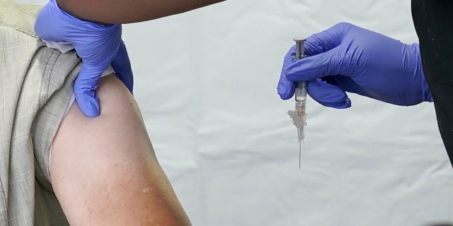 Governor of Washington, Jay Inslee (left), was vaccinated against influenza by Kaiser Permanente's nurse, Senetrapikens, at the Capitol in Olympia, Washington, on Thursday, October 15, 2020.