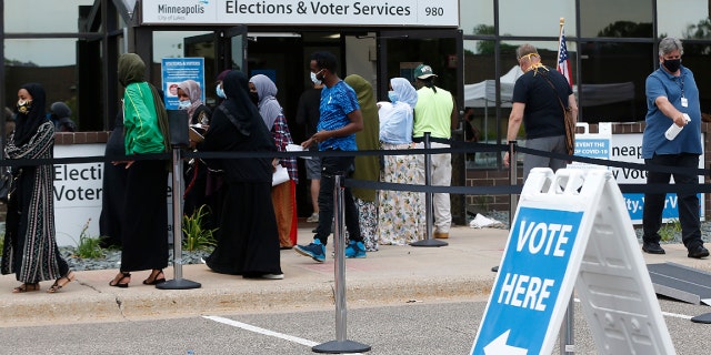 Minneapolis voters line up to vote a day ahead of Minnesota's Tuesday primary election at the Minneapolis Election and Voters Services offices. (AP Photo/Jim Mone, File)