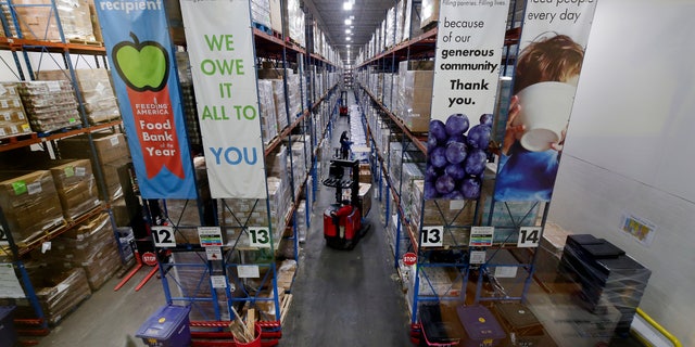 Pallets of various foods are stacked on shelves in the warehouse at the Houston Food Bank on Oct. 14. (AP Photo/Michael Wyke)