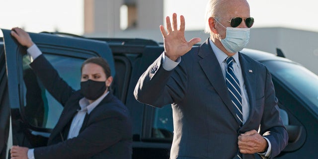 Democratic presidential candidate former Vice President Joe Biden waves as he walks to board his campaign plane at Raleigh-Durham International Airport in Morrisville, N.C., Sunday, Oct. 18, 2020, en route to Wilmington, Del. (AP Photo/Carolyn Kaster)