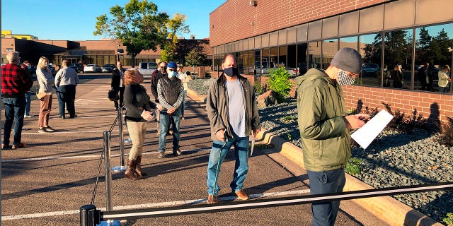 Voters line up outside of the Minneapolis early voting center as Minnesota opened early voting for the general election. (AP Photo/Steve Karnowski, File)
