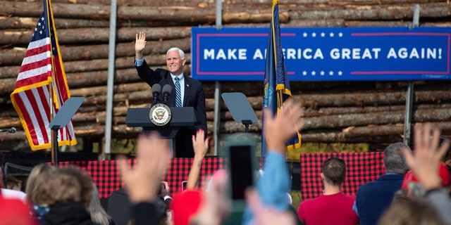 Vice President Mike Pence waves to supporters at a campaign rally, Monday, Oct. 19, 2020, at Dysarts in Hermon, Maine. (Linda Coan O'Kresik/The Bangor Daily News via AP)