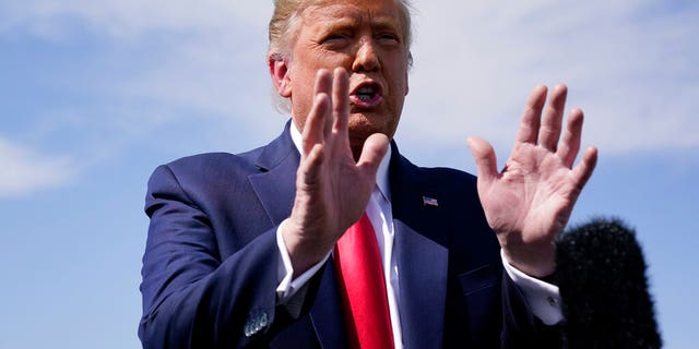 President Donald Trump talks to reporters at Phoenix Sky Harbor International Airport, Monday, Oct. 19, 2020, in Phoenix. 