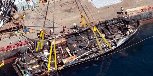 In this Sept. 12, 2019, file photo, the burned hull of the dive boat Conception is brought to the surface by a salvage team off Santa Cruz Island, Calif. (Brian van der Brug/Los Angeles Times via AP)