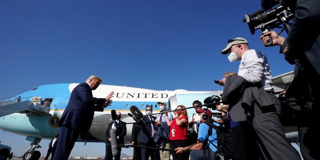 President Donald Trump speaks to reporters at Phoenix Sky Harbor International Airport, Monday, Oct. 19, 2020, in Phoenix. (AP Photo/Alex Brandon)