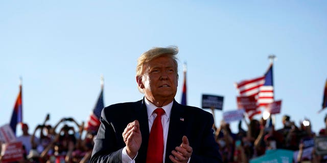 President Donald Trump applauds after a campaign rally at Tucson International Airport, Monday, Oct. 19, 2020, in Tucson, Ariz. (AP Photo/Alex Brandon)