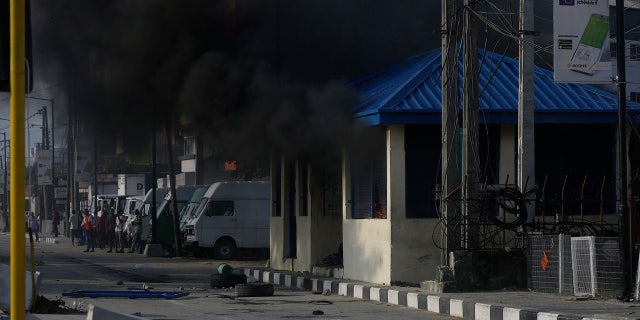After 13 days of protests against alleged police brutality, authorities have imposed a 24-hour curfew in Lagos, Nigeria's largest city, as moves are made to stop growing violence. ( AP Photo/Sunday Alamba)