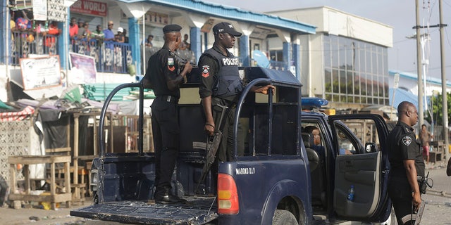 Police officers patrol near the Lekki toll gate in Lagos, Nigeria, Wednesday Oct. 21, 2020. ( AP Photo/Sunday Alamba)
