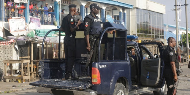 Police officers patrol near the Lekki toll gate in Lagos, Nigeria, Wednesday Oct. 21, 2020. ( AP Photo/Sunday Alamba)