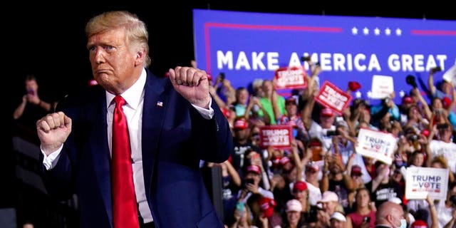 President Donald Trump dances after a campaign rally at Pensacola International Airport, Friday, Oct. 23, 2020, in Pensacola, Fla. (AP Photo/Evan Vucci)