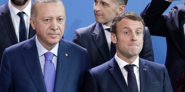 In this Sunday, Jan. 20, 2020 file photo, Turkey's President Recep Tayyip Erdogan, left and French President Emmanuel Macron stand, during a group photo at a conference on Libya at the chancellery in Berlin, Germany. France has recalled its ambassador to Turkey after Turkish President Recep Tayyip Erdogan said President Emmanuel Macron needed mental health treatment and made other comments that the French government described as unacceptably rude. (AP Photo/Michael Sohn, File)