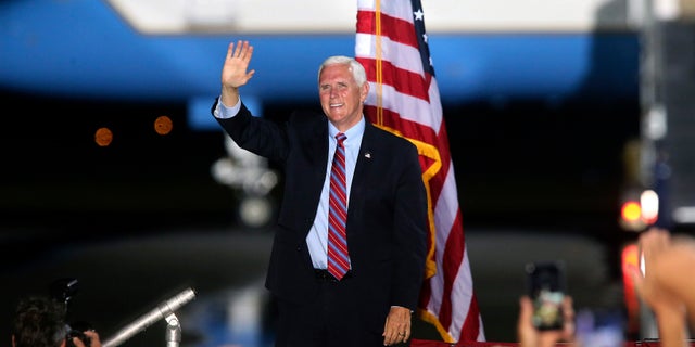 Vice President Mike Pence waves to supporters Saturday Oct. 24, 2020, in Tallahassee, Fla. (AP Photo/Steve Cannon)