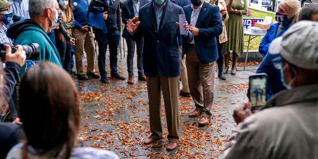 Democratic presidential candidate former Vice President Joe Biden speaks with people outside a voter service center, Monday, Oct. 26, 2020, in Chester, Pa. (AP Photo/Andrew Harnik)