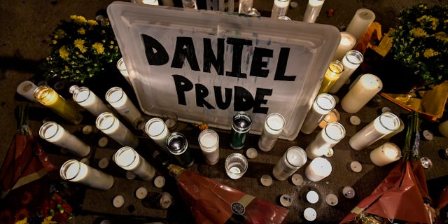 In this Sept. 2, 2020, file photo, candles light a makeshift memorial for Daniel Prude, a Black man who died while restrained and in police custody in Rochester, N.Y., in March. (AP Photo/Adrian Kraus, File)