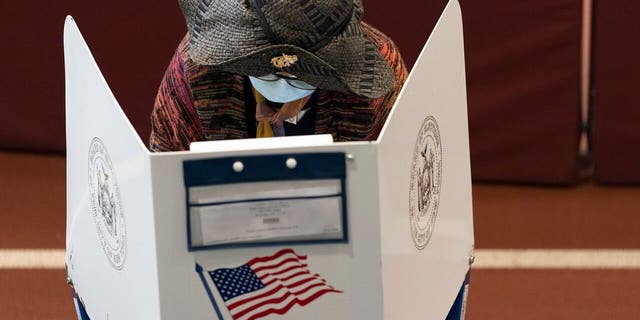 A voter marks her ballot during early voting at the Park Slope Armory YMCA, Tuesday, Oct. 27, 2020, in the Brooklyn borough of New York. (AP Photo/Mary Altaffer)