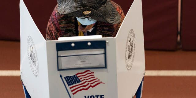 A voter marks her ballot during early voting at the Park Slope Armory YMCA, Tuesday, Oct. 27, 2020, in the Brooklyn borough of New York. (AP Photo/Mary Altaffer)