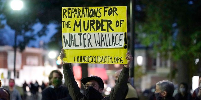 Protesters gather for a march Tuesday in Philadelphia. Hundreds of demonstrators marched in West Philadelphia over the death of Walter Wallace, a Black man who was killed by police in Philadelphia on Monday. His family is calling for justice after viewing police body camera footage of the fatal encounter Thursday. (AP Photo/Matt Slocum)