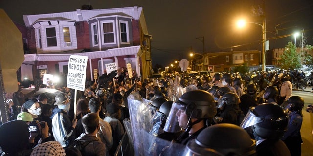 Protesters face off with police during a demonstration Tuesday in Philadelphia. (AP Photo/Michael Perez)