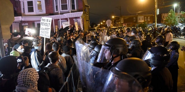 Protesters face off with police during a demonstration Tuesday in Philadelphia. (AP Photo/Michael Perez)