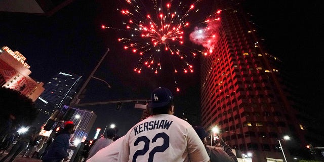 Baseball fans celebrate downtown after the Los Angeles Dodgers won the World Series over the Tampa Bay Rays Tuesday, Oct. 27, 2020, in Los Angeles. (AP Photo/Ashley Landis)