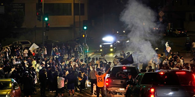 Los Angeles Dodgers fans block traffic on Sunset Boulevard after watching the broadcast of Game 6 of the baseball World Series in Los Angeles on Tuesday, Oct. 27, 2020. The Los Angeles Dodgers defeated the Tampa Bay Rays 3-1 and won the World Series. (AP Photo/Damian Dovarganes)