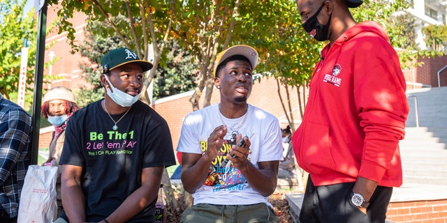 NBA star and current Winston-Salem State University student Chris Paul talks basketball with Winston-Salem State University students, from left, Donovan Tillman and Zayquan Osborne on Tuesday, Okt.. 27, 2020, in Winston-Salem, N.C. (Andrew Dye/The Winston-Salem Journal via AP)